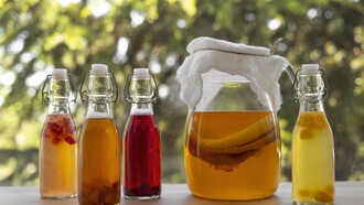 An artful still life composition featuring a bottle of kombucha
