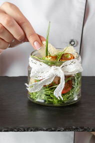 A chef presenting an enticing dish, showcasing current culinary trends