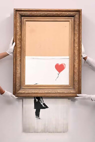 Gallery employees pose with Love is in the Bin by Banksy, photo by Facundo Arrizabalaga/EPA