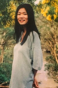 A young Kim Chi Pho in a garden in the middle of autumn