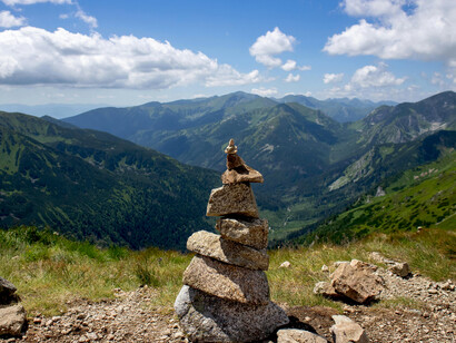 Stacked stones set against the backdrop of the Himalayas