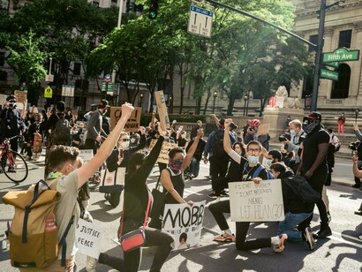 Protesters in New York, United States, gather with raised arms and signs, embodying the spirit of activism and collective resistance