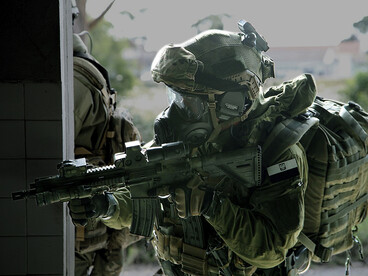 A soldier in the Polish Multi-role exploitation Reconnaissance Team (MRT) conducts a security check of the a building suspected of having hazardous material in Lisbon, Portugal on October 29, 2015 during NATO exercise