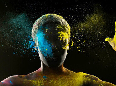 Model with vibrant powder, eyes peacefully closed, embodying mindfulness and deep inner communication