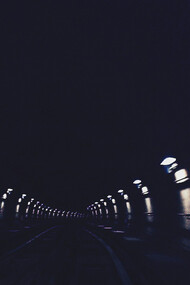 A dimly lit tunel, extending into the darkenss