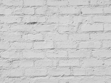 A white-painted brick wall showcasing subtle texture