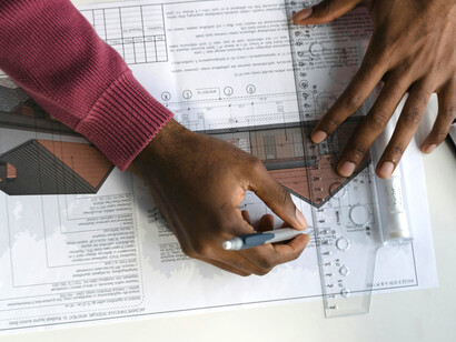 A student of architecture focused on drafting blueprints, combining study and design in one creative process