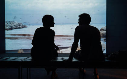 A couple reconnecting in front of the ocean