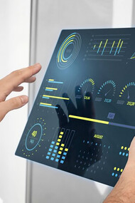 Close-up of a hand holding a futuristic digital screen