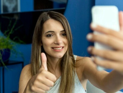 An adult woman using multiple devices, reflecting the challenge of balancing screen time