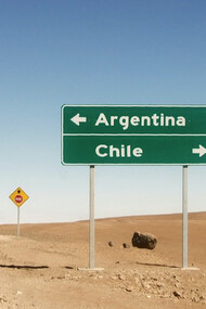 Border between Argentina and Chile in Bolivia, where the signs of both nations stand as symbols of national identity by L'odyssée Belle