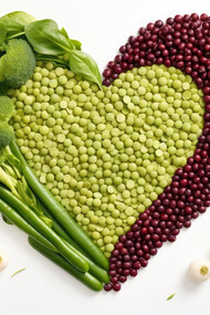 Lentils and green beans forming a heart on a white background healthy food concept 