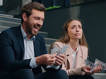 In the city, a wealthy businessman counts his money while a frustrated businesswoman looks on, highlighting income inequality and financial injustice