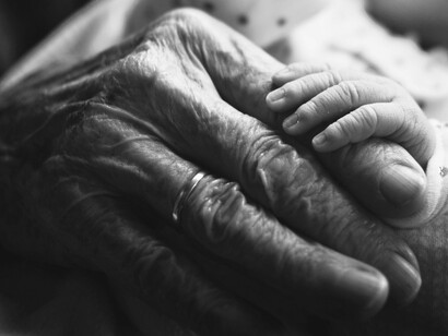 In the quiet meeting of generations, the illusion of time dissolves into presence
