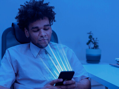 A person looking at their phone, highlighting facial recognition technology, biometric security, AI surveillance, and privacy concerns in biometric identification