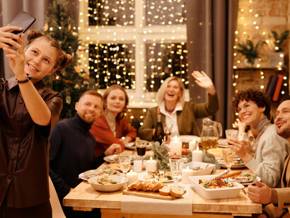 A family enjoying their Christmas dinner and taking a selfie together