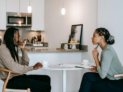 A psychologist writing notes during a therapy session