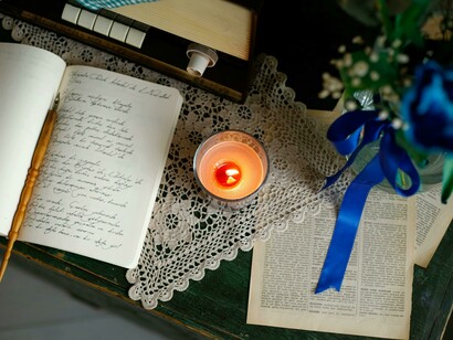 A diary resting by candlelight, indicating the value of self-reflection