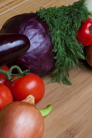 A vibrant medley of tomatoes, peppers, onions, and eggplants adorns the chopping board, evoking the rich tapestry of Turkish cuisine