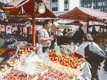 Vibrant stalls and hurried footsteps merge into a symphony of color and noise