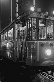 A red trolley car moves along a street in Istanbul, Türkiye, under the glow of the night