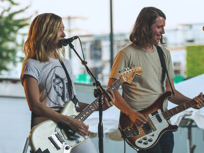 A duo performing with their electric guitars, representing how music connects people from different cultures