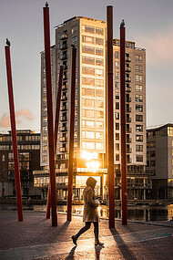A woman walking through the streets of Dublin, Ireland, at sunset