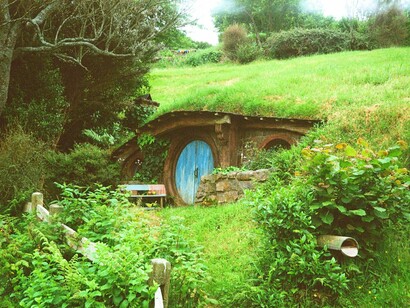 An underground home beneath grassy mounds  in New Zealand, reflecting the balance between innovation and ecological respect