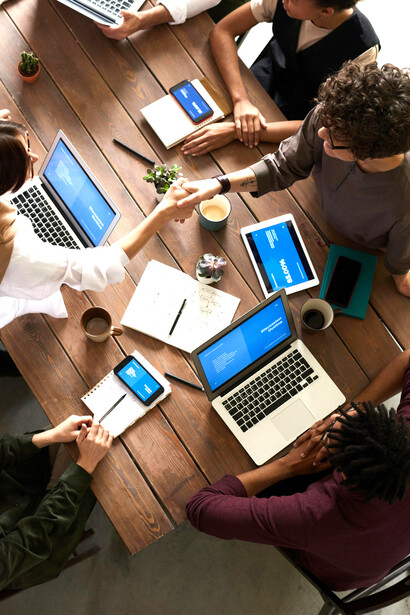 Diverse tech team with women actively engaged in discussing technology and data ethics around a table