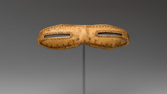 Snow goggles, dating from circa 800–1200, carved from walrus ivory and measuring 1 1/8 × 5 inches (2.9 × 12.7 cm), are part of the American Wing collection at the Metropolitan Museum of Art, USA