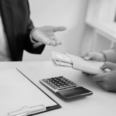 A businessman accepts money and a brown envelope from a file, symbolizing office bribery and corruption