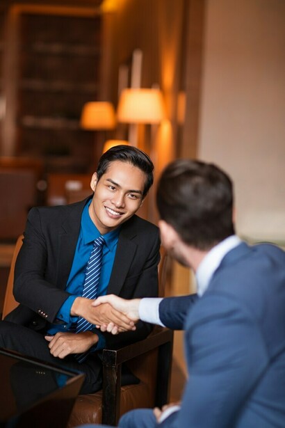 Two people sealing a morally ambiguous handshake over lattes—probably debating Kant vs. egoism