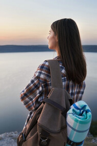 A traveler pauses to soak in stillness, embracing the essence of slow travel 