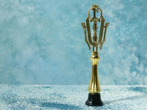 A trophy set against a simple blue background, representing the quiet significance of small achievements