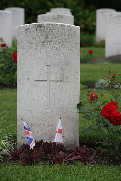 Red roses placed on a World War II war grave in Geel Cemetery, Flanders, Belgium