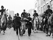 Eddie Worth, An anti-fascist demonstrator is taken away under arrest after a mounted baton charge during the Battle of Cable Street, London, 4, October 1936. Courtesy of the National Galleries of Scotland