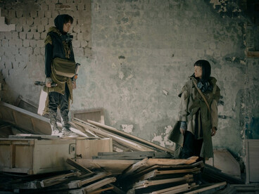 A man and a woman navigating a post-apocalyptic setting, symbolizing resilience in the face of uncertainty and loss