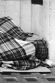 "Man Sleeping in a Theater Doorway," photograph, Allan Warren, 2015