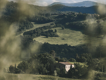 A couple sitting together on a bench in the green countryside, surrounded by the quiet beauty of the moors
