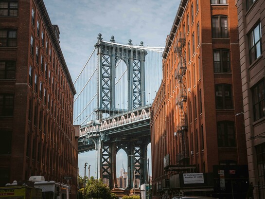 The Manhattan Bridge framed between buildings in New York City, United States