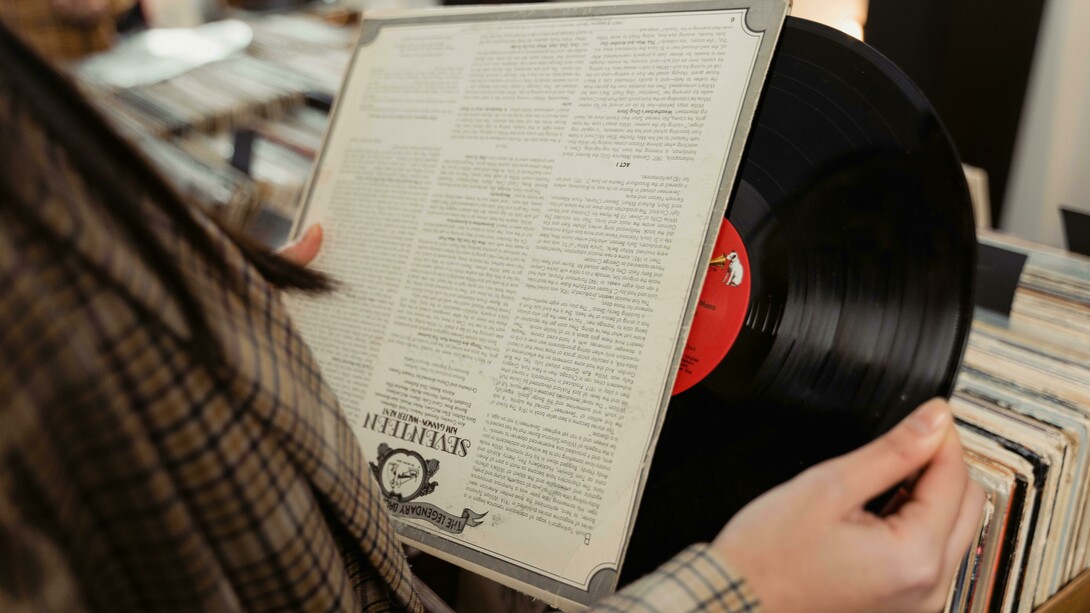 A person looking closely at a vinyl record