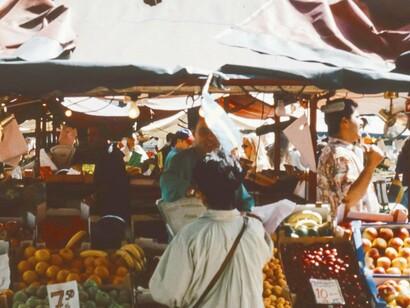 “Energy, noise, and overflowing goods create a vibrant yet uneasy atmosphere