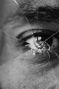 Eyes reflected in a shattered mirror, symbolizing critical thinking and the struggle between truth and illusion